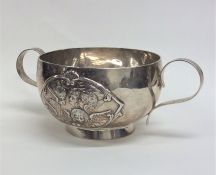 An Edwardian silver two handled cup mounted with c