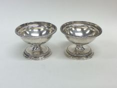 A pair of heavy circular Georgian silver salts wit