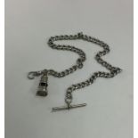 A silver curb link watch chain with bar. Approx. 5