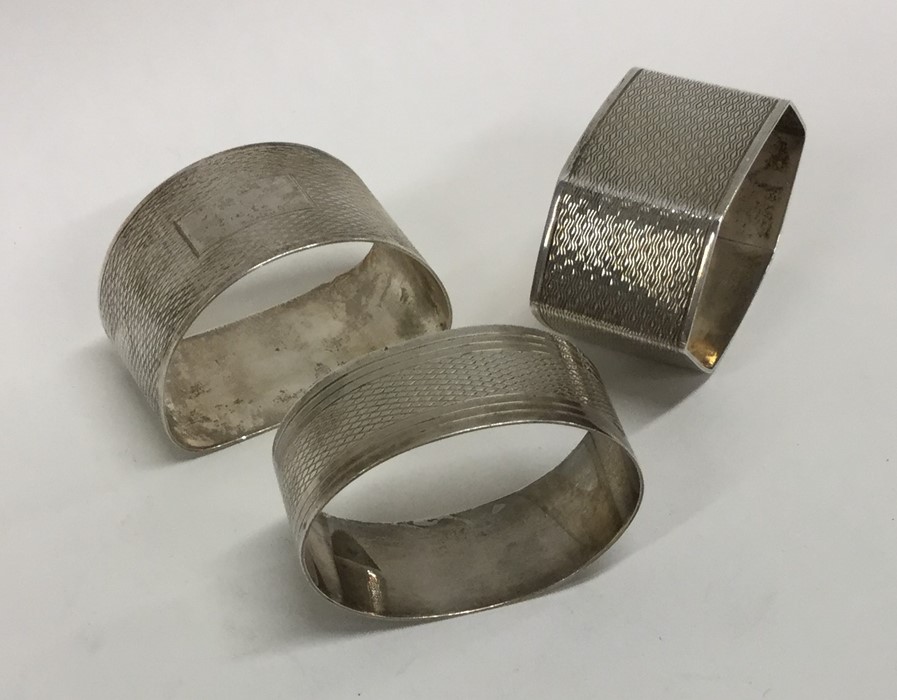 Three silver engine turned napkin rings. Approx. 6