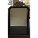 An unusual ebony and silvered wall mirror with che