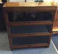 An oak glazed three section bookcase. Est. £20 - £