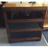 An oak glazed three section bookcase. Est. £20 - £