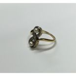 A Continental diamond and pearl twist ring with ru
