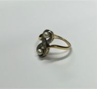 A Continental diamond and pearl twist ring with ru