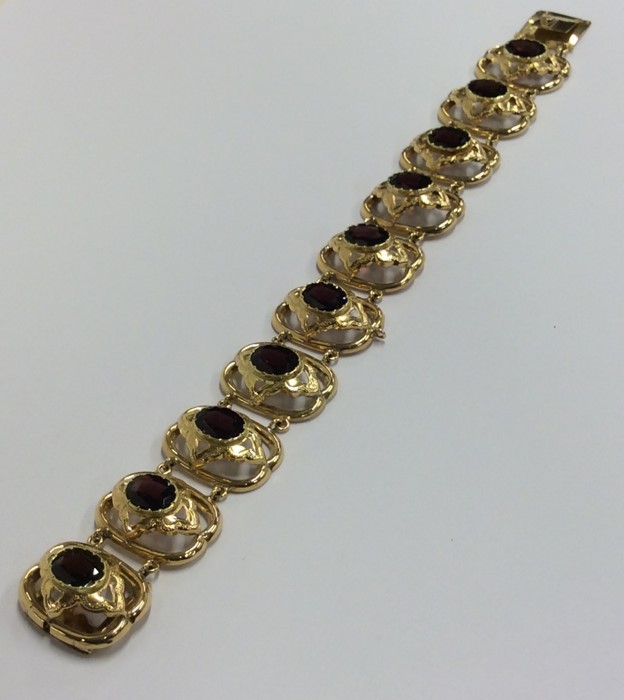 A garnet ten stone panelled bracelet with conceale