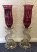 A pair of stylish moulded glass lamps with cranber