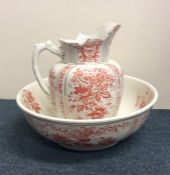 A large decorative gilt jug and basin set with pin