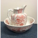 A large decorative gilt jug and basin set with pin