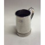 A Chinese silver tapering mug with crested front.