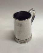 A Chinese silver tapering mug with crested front.