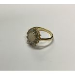 An 18 carat gold opal and diamond cluster ring. Ap