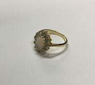 An 18 carat gold opal and diamond cluster ring. Ap