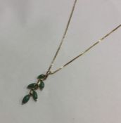 A heavy gold and jade pendant on fine link chain.