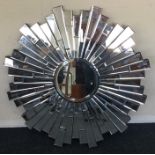 A stylish circular hall mirror of textured form. A