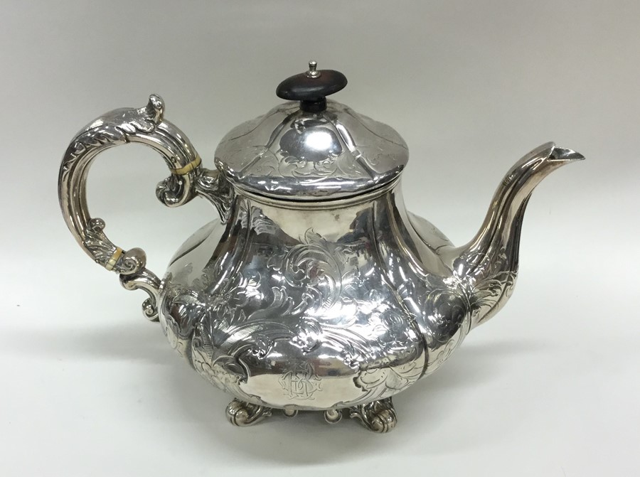 An attractive Victorian engraved silver teapot on