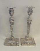 A tall matched pair of large silver candlesticks w
