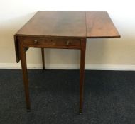 A mahogany two flap Pembroke table on tapering sup