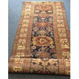 An Antique long runner decorated with bright colou