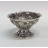 A Victorian embossed silver sugar bowl decorated w