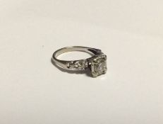 A large Art Deco single stone ring with carved sho