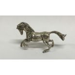 A silver model of a galloping horse with textured