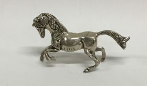 A silver model of a galloping horse with textured