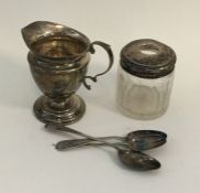 A silver cream jug together with a silver mounted