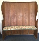 A large baker's settle with panelled back and shap