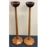 A pair of stylish tall wooden candlesticks of tape