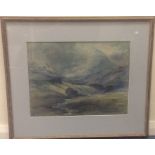A framed and glazed watercolour depicting a hillly