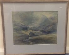 A framed and glazed watercolour depicting a hillly