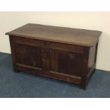 A Georgian oak hinged top coffer with plank top. E