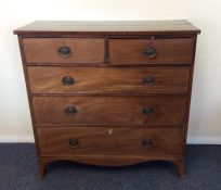 A Georgian mahogany chest of five drawers with bra