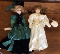 Two dressed porcelain headed dolls; one in green g