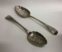 A matched pair of Georgian silver berry spoons wit