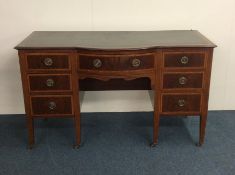 A late Victorian mahogany seven drawer desk on tap