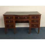 A late Victorian mahogany seven drawer desk on tap