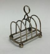 A heavy silver five bar toast rack / smartphone do