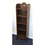 A tall oak slim bookcase. Est. £25 - £35.