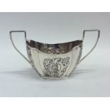 An Edwardian silver sugar bowl with floral decorat