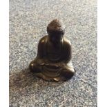 A small brass model of a seated Buddha. Seal mark
