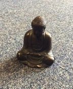 A small brass model of a seated Buddha. Seal mark