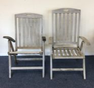 A pair of reclining teak garden chairs. Est. £30 -