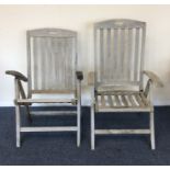 A pair of reclining teak garden chairs. Est. £30 -