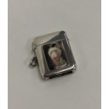 A hinged top silver vesta case with enamel decorat