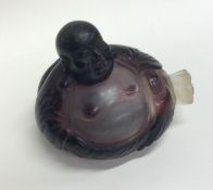 An unusual amethyst glass scent bottle in the form