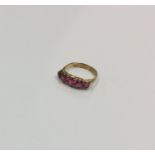 An Antique ruby five stone half hoop ring in claw