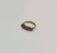 An Antique ruby five stone half hoop ring in claw