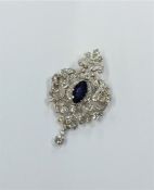 A massive sapphire and diamond drop pendant set in